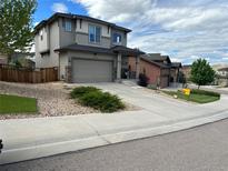 Charming two-story home with a two-car garage, rock landscaping and a concrete driveway at 3173 Youngheart Way, Castle Rock, CO 80109