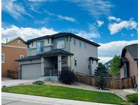 Charming two-story home features a well-manicured lawn and attached two-car garage at 3173 Youngheart Way, Castle Rock, CO 80109