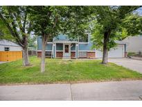 Charming two-story home featuring an attractive blue exterior and a well-maintained front lawn at 4678 S Lewiston Way, Aurora, CO 80015