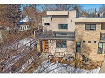 Modern two-story home with stone accents and a private patio at 3323 W Hayward Pl, Denver, CO 80211