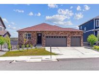 Charming ranch home featuring a three-car garage and brick exterior, set against a blue sky at 4992 Trails Edge Ln, Castle Rock, CO 80104