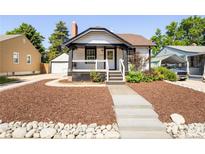 Charming single-Gathering home featuring a quaint front porch and well-maintained landscaped yard at 3755 S Sherman St, Englewood, CO 80113