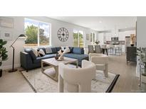 Open living area with sectional sofa, fireplace, and large windows at 4018 Upham St, Wheat Ridge, CO 80033