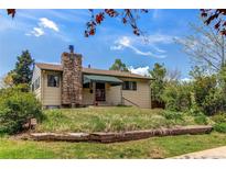 Charming single-story home with a stone chimney and well-maintained front yard at 1275 Niagara St, Denver, CO 80220