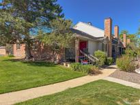 Charming townhome with a well-manicured lawn, mature trees, and brick accents at 4231 S Fairplay Cir # A, Aurora, CO 80014