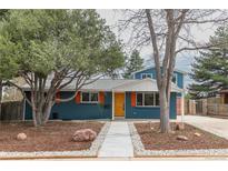 Charming exterior of a two-story home featuring blue paint, a well-manicured lawn, and tasteful landscaping at 1120 Hartford Dr, Boulder, CO 80305