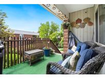 Cozy outdoor patio with comfortable wicker furniture and charming decor under a sunny sky at 3663 S Sheridan Blvd # O15, Denver, CO 80235