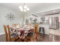 Dining room that is open to kitchen, featuring wood table with seating for four at 3541 E 118Th Ave, Thornton, CO 80233