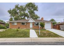 Charming brick ranch-style home with a well-manicured lawn and a cozy, inviting appeal at 8471 Rainbow Ave, Denver, CO 80229