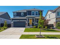 Beautiful two-story home featuring a yellow front door, attached garage, and well-maintained front yard at 27130 E Maple Ave, Aurora, CO 80018