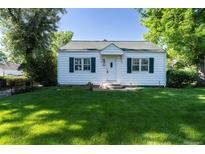 Charming home with a well-manicured lawn and mature trees at 5680 W 41St Ave, Wheat Ridge, CO 80212