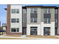 Modern townhome showcasing varied textures and contemporary design elements at 451 Interlocken Blvd # 104, Broomfield, CO 80021