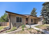 Charming single-story home with a well-maintained front yard and a classic brick facade at 2043 S Salida St, Aurora, CO 80013