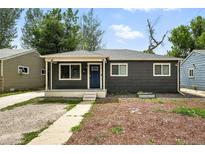 Charming single-story home features a well-maintained lawn and a welcoming front porch, creating an inviting curb appeal at 1941 Alton St, Aurora, CO 80010