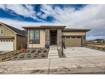 Charming single-Gathering home featuring stone pillars, a modern design and an attached two car garage at 454 Basin Daisy St, Castle Rock, CO 80104