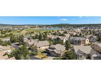 Expansive aerial view of a desirable community with mature trees and a serene lake at 1660 Moveen Hts, Monument, CO 80132