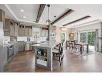 Modern kitchen with granite countertops and island at 1729 Santa Fe Mountain Rd, Evergreen, CO 80439