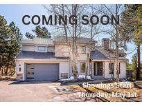 Charming home with stone accents, well-maintained landscaping, and a two-car garage offers curb appeal at 2122 Cramner Ct, Evergreen, CO 80439
