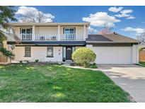 Charming two-story home with a front yard and a covered balcony providing inviting curb appeal at 6660 E Floyd Ave, Denver, CO 80224