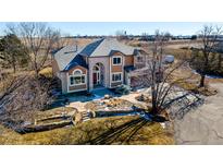 Two-story house with stone accents and landscaping; driveway and yard visible at 15050 Harrison St, Brighton, CO 80602