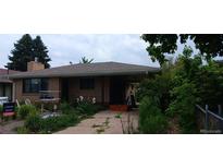 Charming home with brick exterior, mature trees, and covered front porch and driveway at 2008 Moline St, Aurora, CO 80010