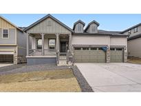 Charming home with covered porch, three-car garage, and modern architectural details at 15616 W Beloit Ave, Morrison, CO 80465