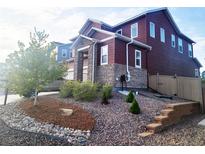 Charming two-story home features stone accents, landscaped front yard, and inviting curb appeal at 4840 Point Mesa St, Castle Rock, CO 80108