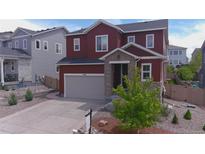 Charming two-story home with stone accents, a well-maintained lawn, and a spacious two car garage at 4840 Point Mesa St, Castle Rock, CO 80108