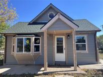 Charming home with a quaint front porch and newly installed windows adding to its curb appeal at 660 Hickory St, Hudson, CO 80642