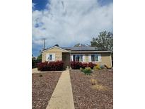 Charming single-story home featuring solar panels, a landscaped yard and a welcoming walkway at 3493 S Eudora St, Denver, CO 80222