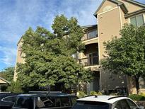 View of the exterior of the building featuring balconies and a well-maintained landscape at 7355 S Alkire St # 203, Littleton, CO 80127