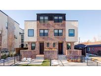 Modern brick three-unit building with two-car garage and landscaped yards at 419 Harrison St, Denver, CO 80206