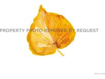 Watercolor painting of a vibrant aspen leaf in shades of yellow and orange, capturing its delicate details at 488 S Leyden St, Denver, CO 80224