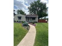 Charming home features a well-manicured lawn and lush landscaping at 488 S Leyden St, Denver, CO 80224