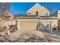 Charming townhome featuring a two-car garage, neutral siding and well-maintained landscaping at 13025 W 63Rd Pl # C, Arvada, CO 80004