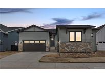 Charming two-story home featuring stone accents, a two-car garage and inviting curb appeal at 11452 Autumn Moon St, Littleton, CO 80125