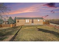 Charming single-story home features a well-maintained lawn and inviting front entrance at 7892 Beverly Blvd, Castle Pines, CO 80108