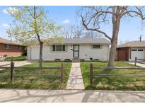 Charming ranch-style home with a well-maintained front yard and traditional white brick at 8012 Zuni St, Denver, CO 80221
