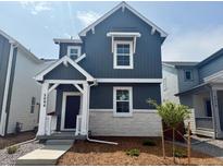 Charming two-story home with a modern exterior and stone accents, complemented by a neatly landscaped front yard at 2086 Wagon Wheel Aly, Brighton, CO 80601