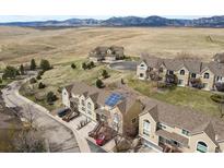 Aerial view of townhomes nestled in a natural setting with mountain views in the distance at 1747 High Plains Ct, Superior, CO 80027