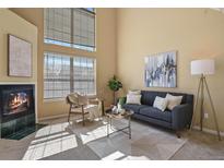 Bright living room with high ceilings, fireplace, and large windows at 1747 High Plains Ct, Superior, CO 80027