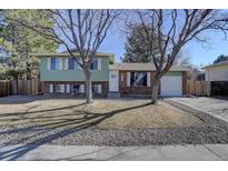 Charming two-story home with mature trees and a well-manicured front yard at 1602 S Lewiston St, Aurora, CO 80017