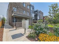 Modern townhouse complex featuring a brick facade, metal accents, and well-maintained landscaping at 1284 Stuart St, Denver, CO 80204