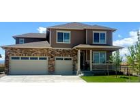 Charming two-story home features a two-car garage, covered porch, and landscaped front yard at 1860 Chaffee Crest Dr, Berthoud, CO 80513