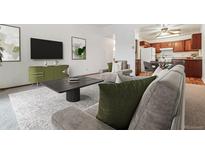 Inviting living room with modern decor, plush seating, and an open layout to the kitchen at 610 S Alton Way # 8D, Denver, CO 80247