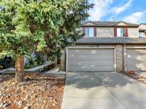 Charming townhome features an attached two-car garage, brick accents, and mature trees at 3529 S Telluride Cir # D, Aurora, CO 80013