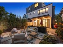 Inviting backyard patio with modern outdoor seating and landscaped planters under ambient lighting at 2248 S Lincoln St, Denver, CO 80210