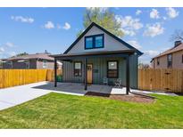 Charming home with a covered porch, well-maintained lawn, and a newly paved driveway at 3680 S Logan St, Englewood, CO 80113