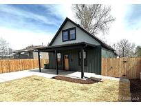 Charming home with a covered porch and a well-maintained front yard and new fence at 3680 S Logan St, Englewood, CO 80113