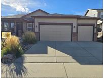 Charming single Gathering home with a three car garage and beautiful xeriscape front yard in a suburban neighborhood at 1927 Rannoch Dr, Longmont, CO 80504